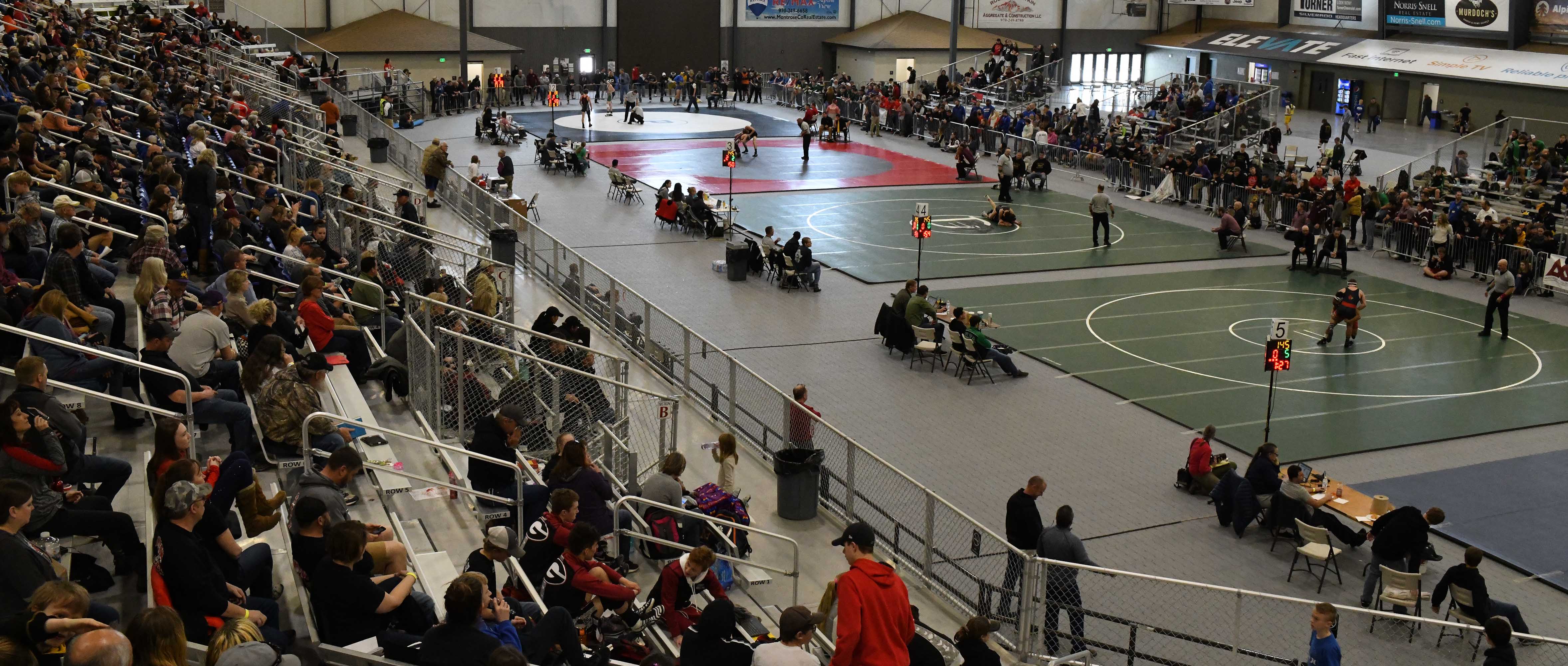 wrestling tournment at event center with people in stadium watching